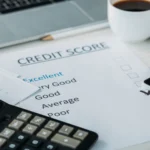 selective focus of smartphone, cup with coffee, calculator, laptop and credit score
